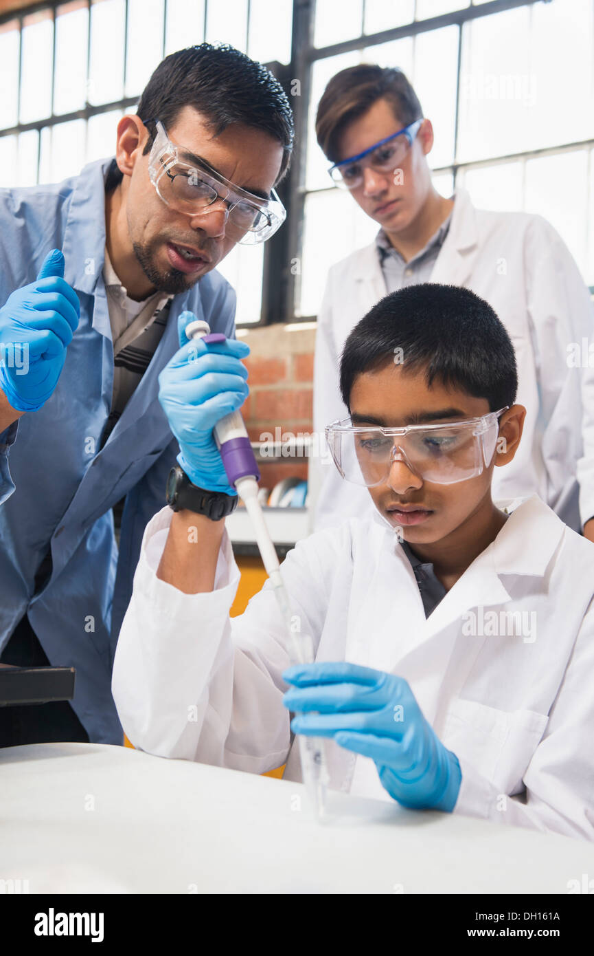 Teacher and students working in science lab Stock Photo Alamy