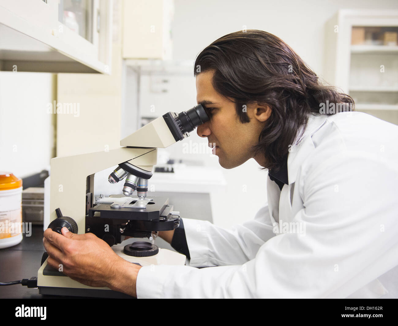 Indian scientist using microscope in laboratory Stock Photo Alamy