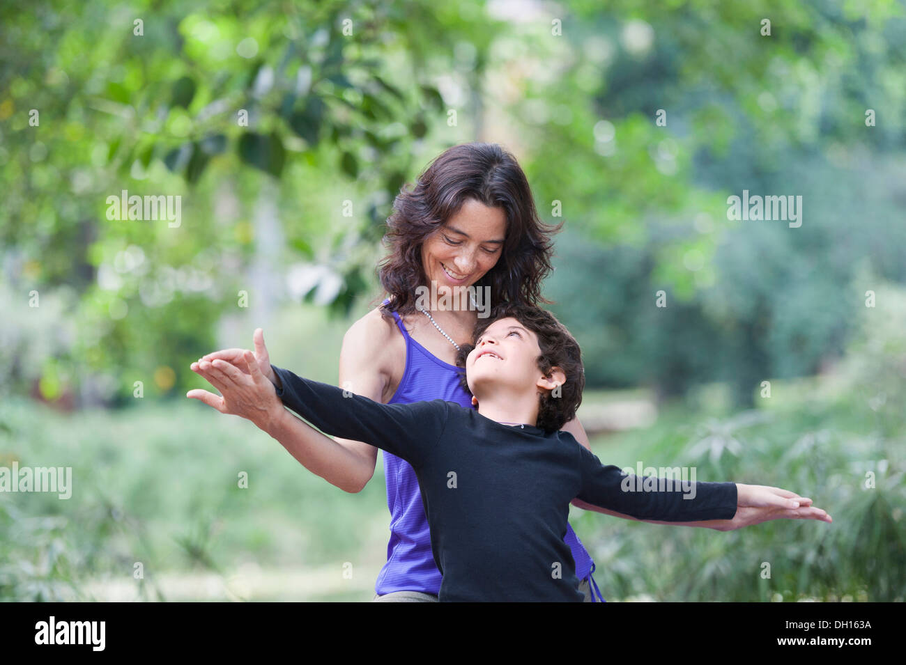 Hispanic mother and son playing outdoors Stock Photo