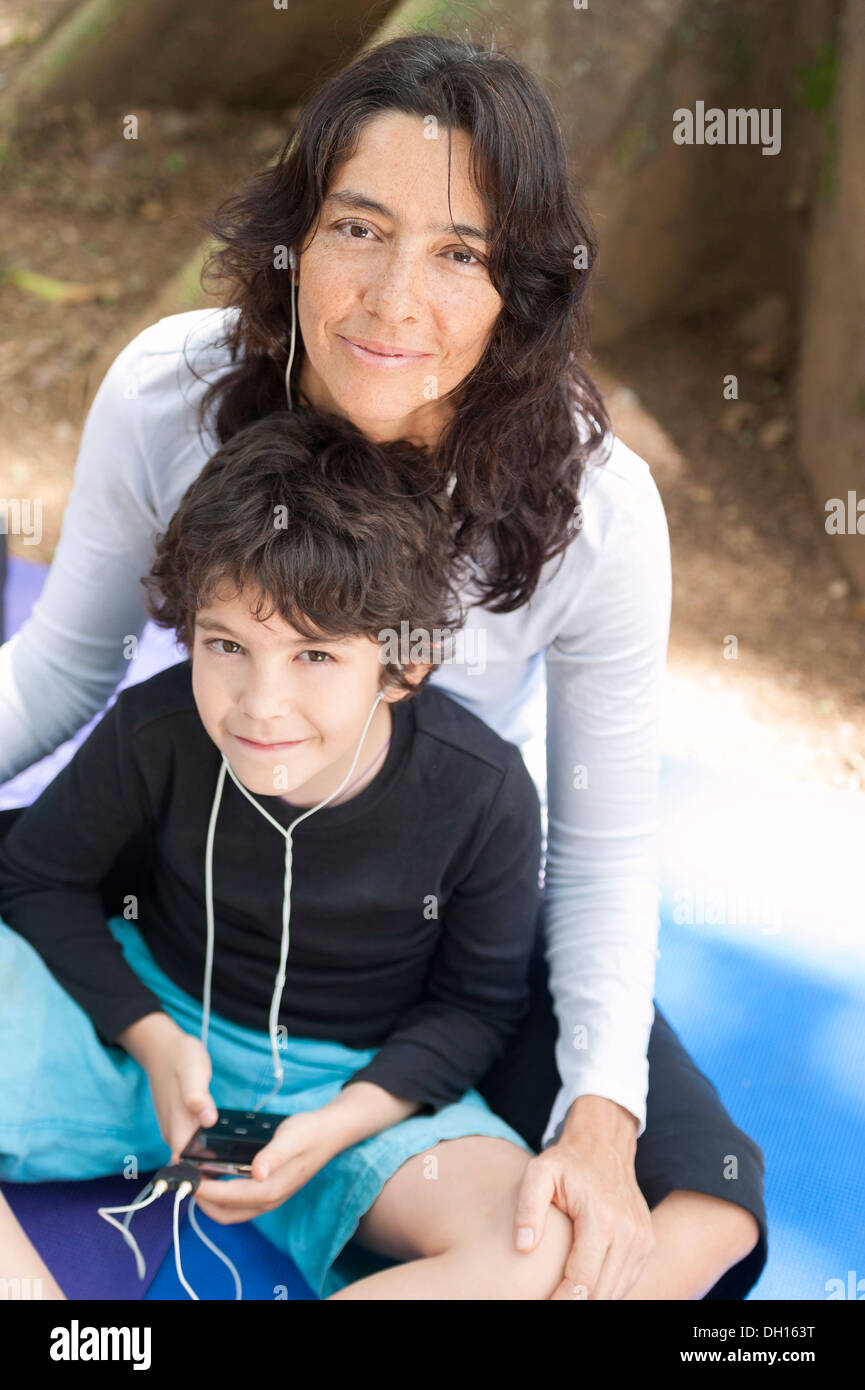 Hispanic mother and son listening to mp3 player Stock Photo