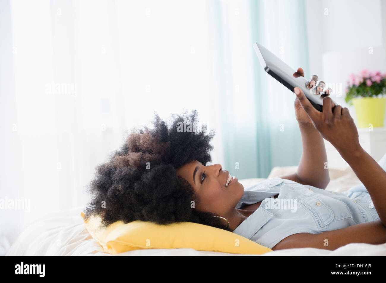 Mixed race woman using digital tablet Stock Photo