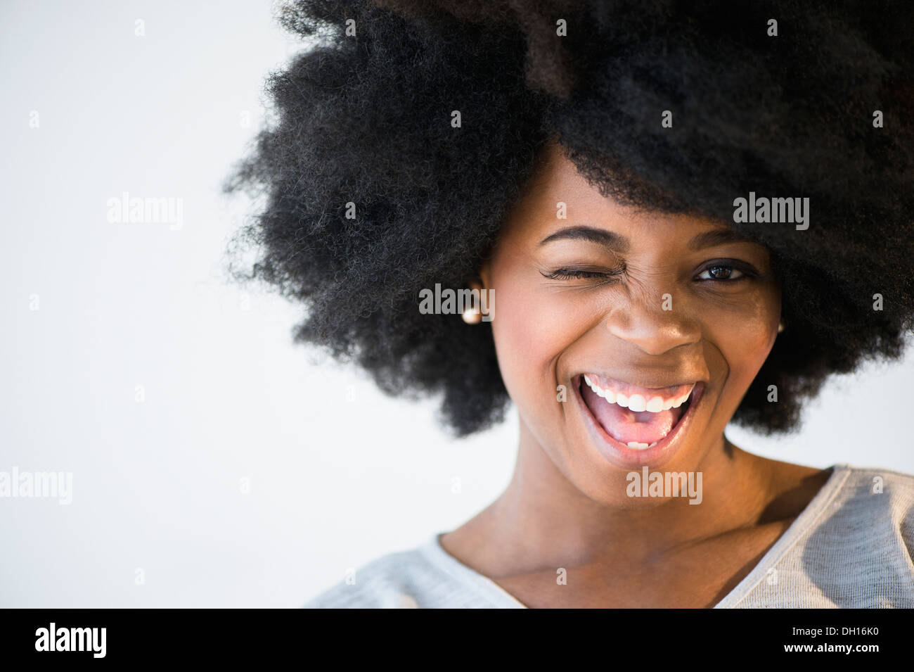 Mixed race woman winking Stock Photo