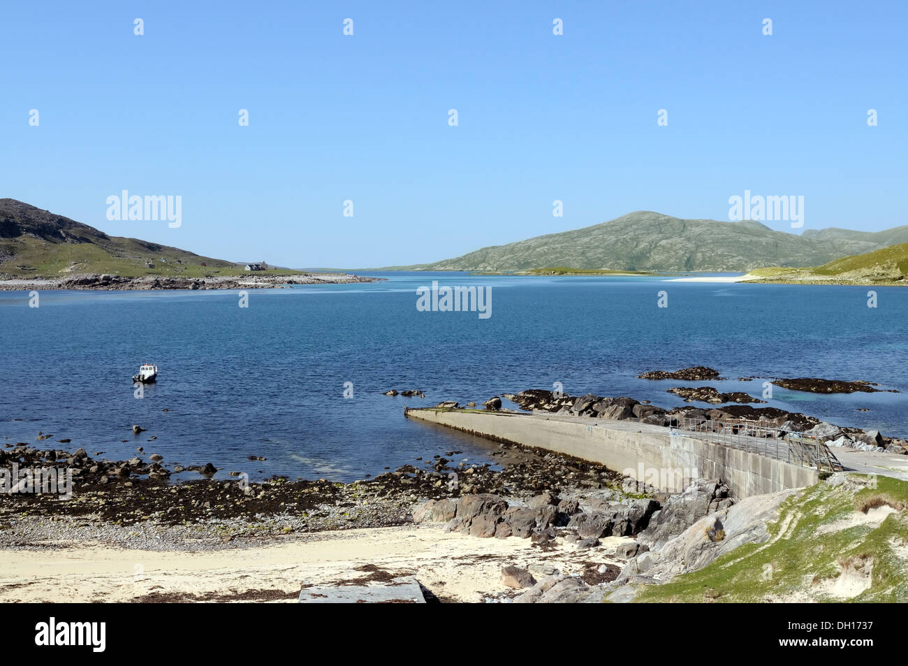 Boat, slipway and beach at Hushinish with view over to Scarp Stock Photo