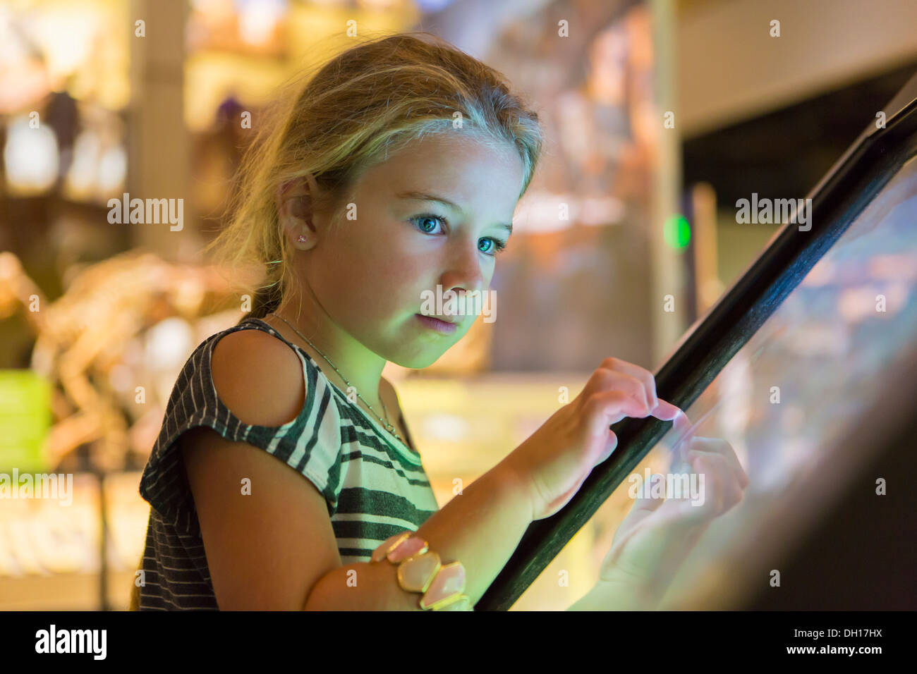 Caucasian girl using touch screen Stock Photo