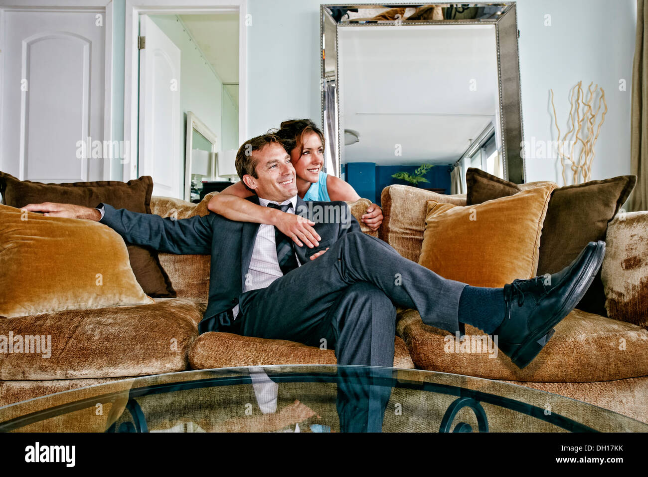 Caucasian couple relaxing on sofa Stock Photo