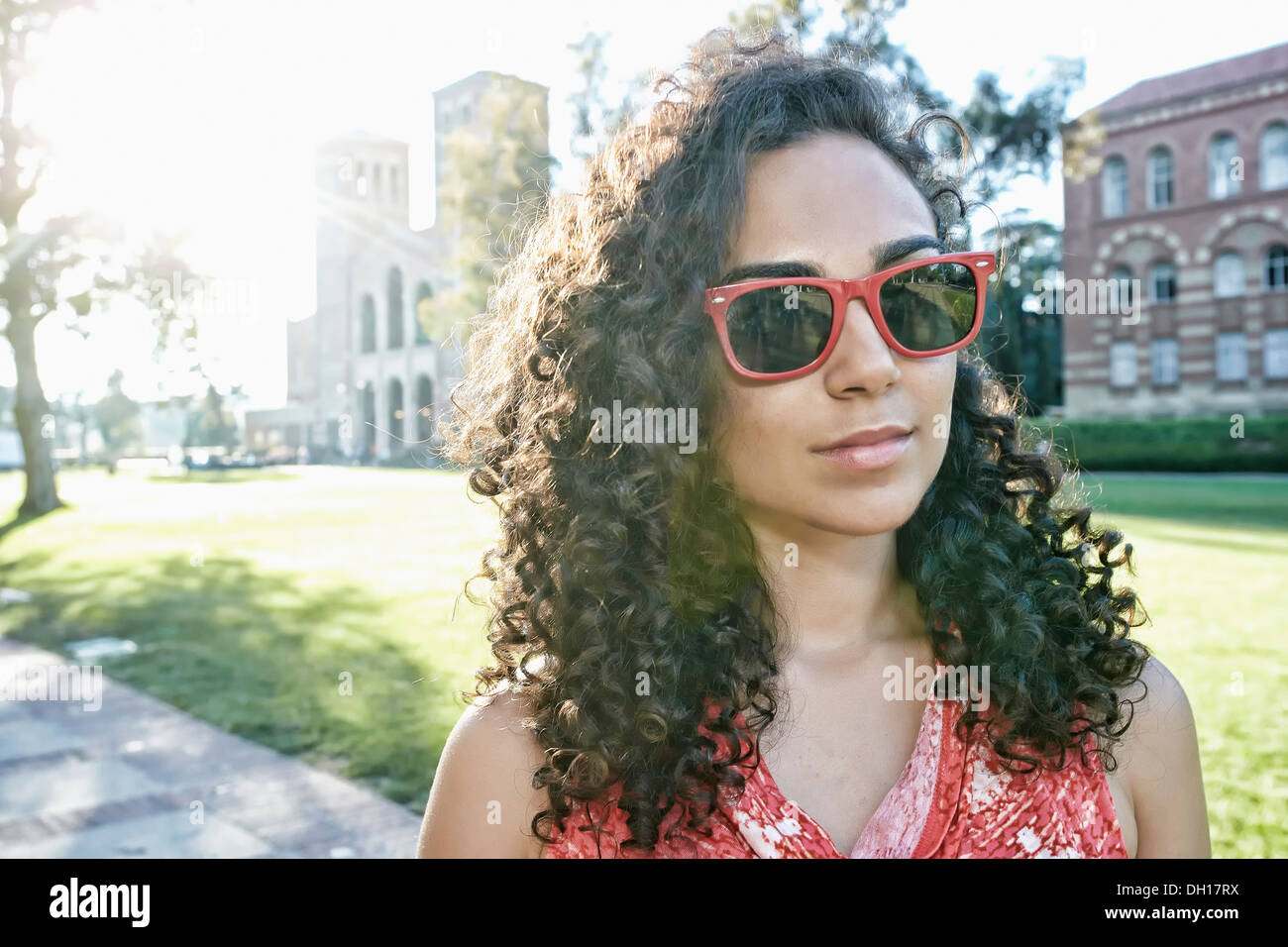 Mixed race student walking on campus Stock Photo Alamy