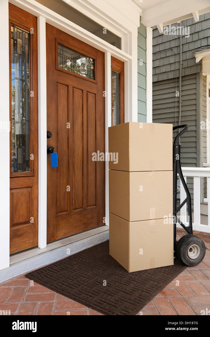 Cardboard boxes on front porch of house Stock Photo