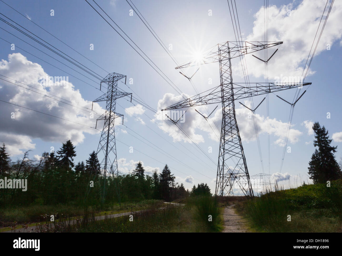 Power lines against blue sky Stock Photo - Alamy