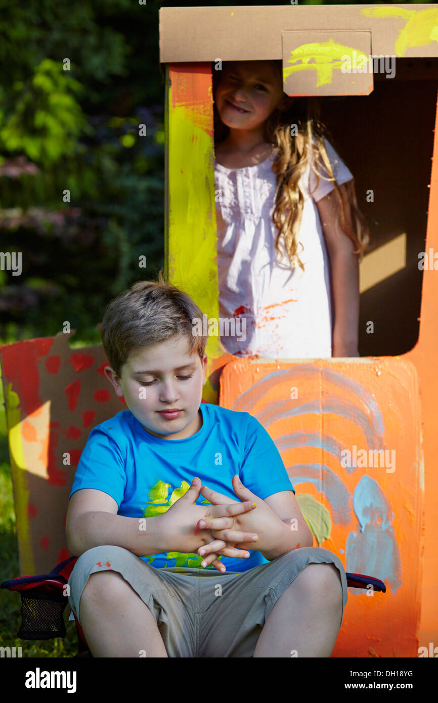Children playing in cardboard box, Munich, Bavaria, Germany Stock Photo
