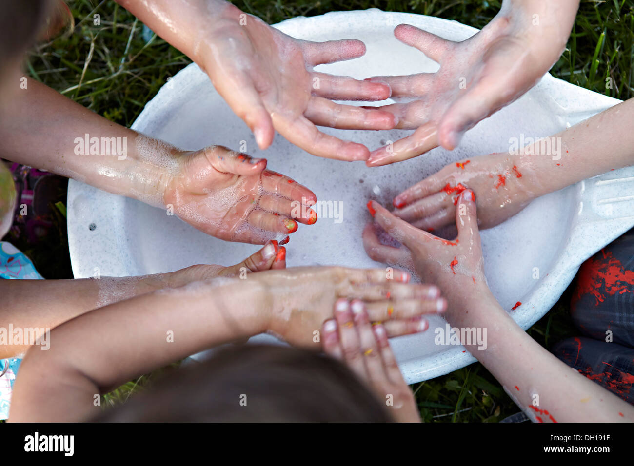 Children washing dirty hands, Munich, Bavaria, Germany Stock Photo