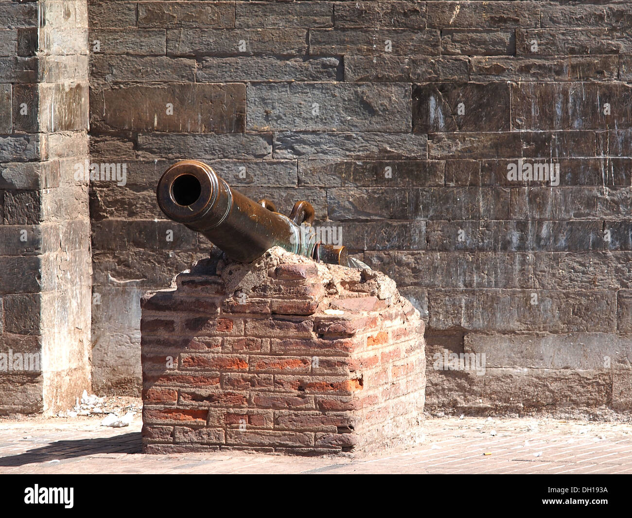 old castiron cannon on the brick wall Stock Photo Alamy