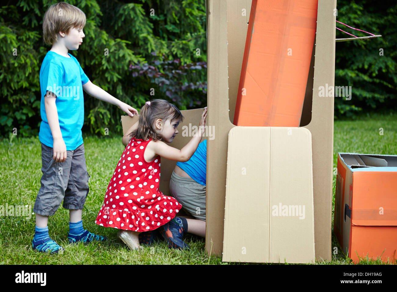 Children playing in cardboard boxes, Munich, Bavaria, Germany Stock