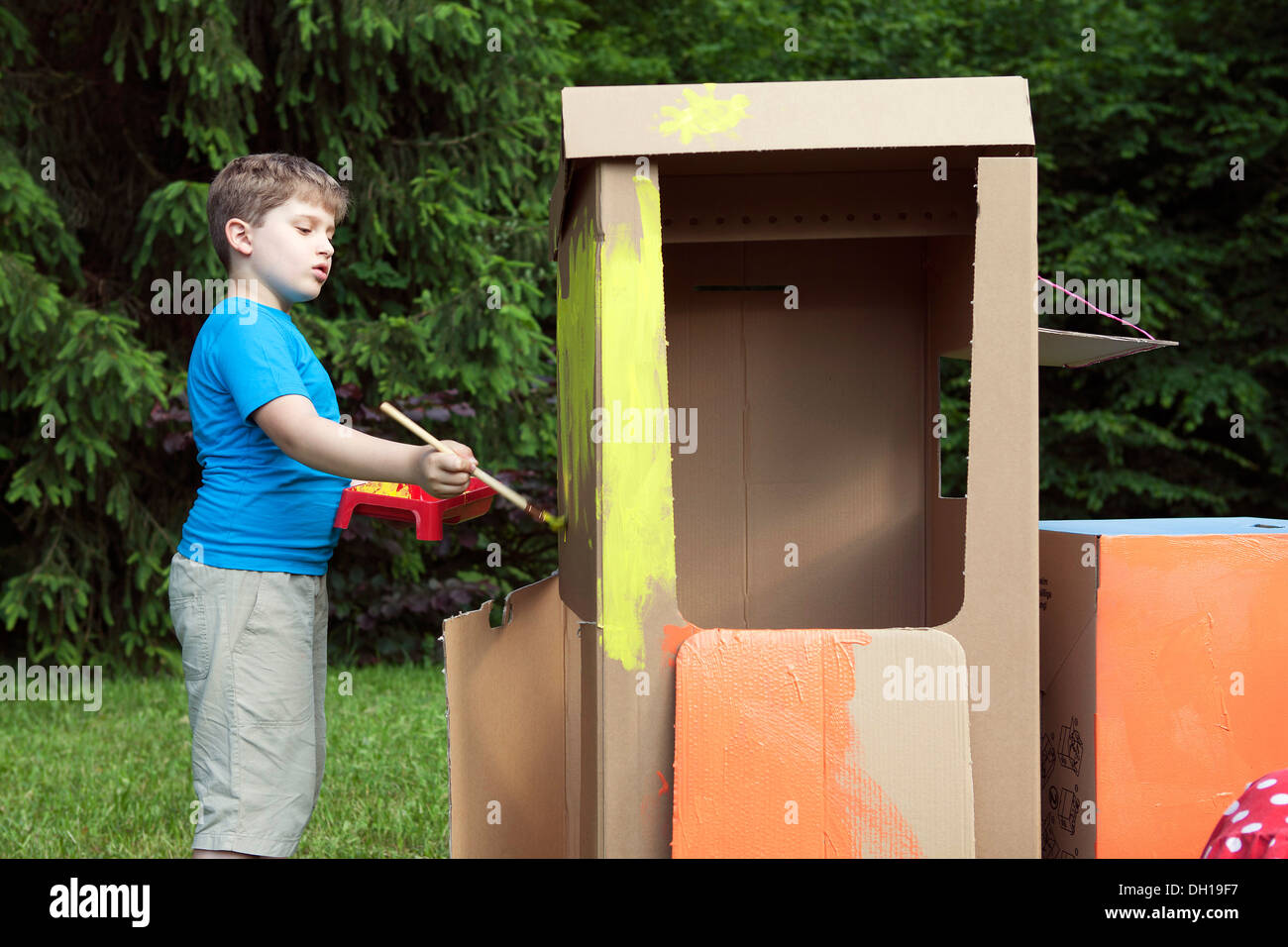 Boy painting cardboard boxes, Munich, Bavaria, Germany Stock Photo Alamy
