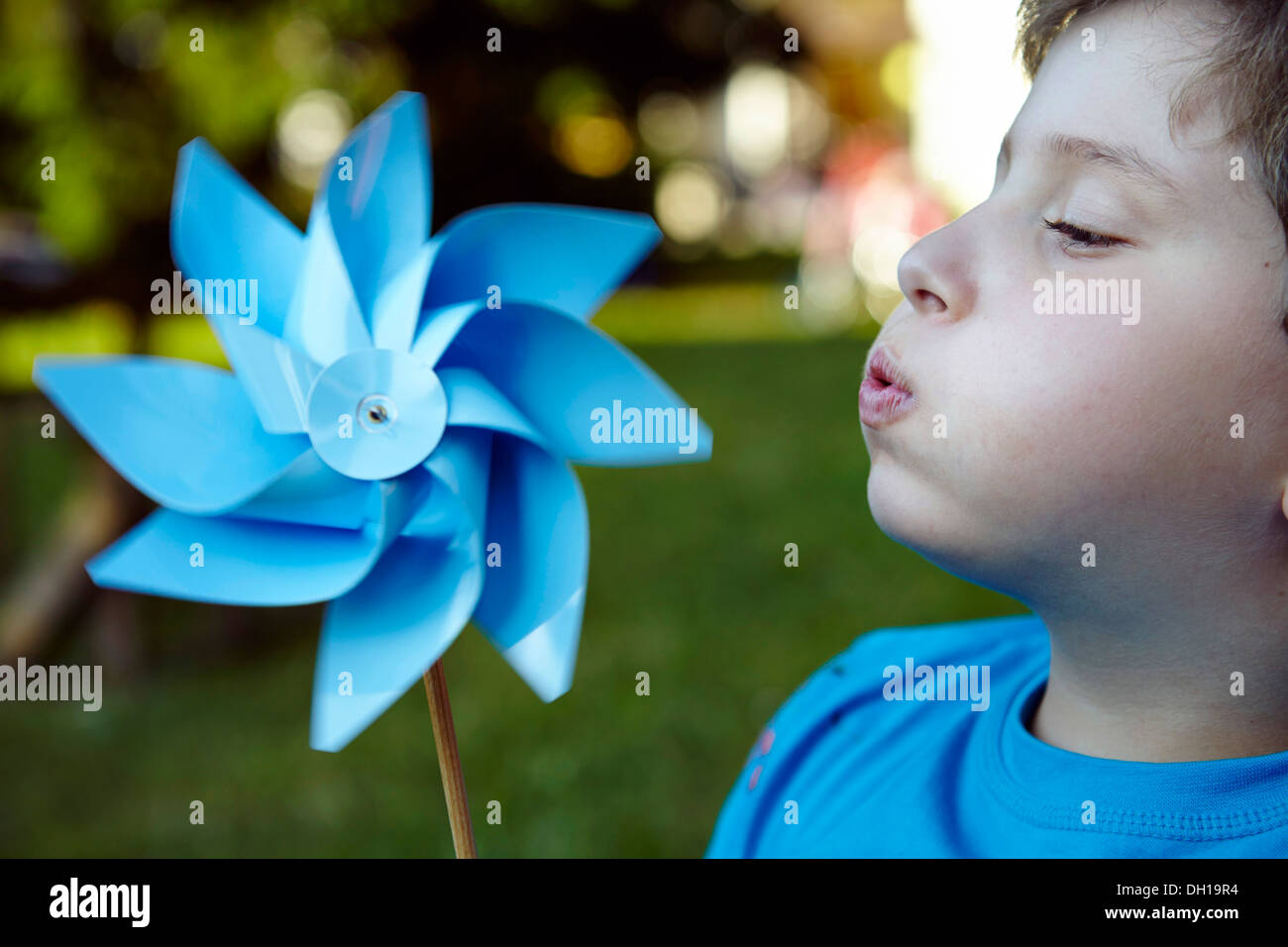 Boy blowing pinwheel, Munich, Bavaria, Germany Stock Photo