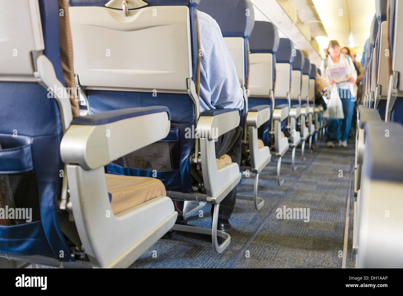 Passengers boarding airplane - interior of commercial airline carrier Stock Photo