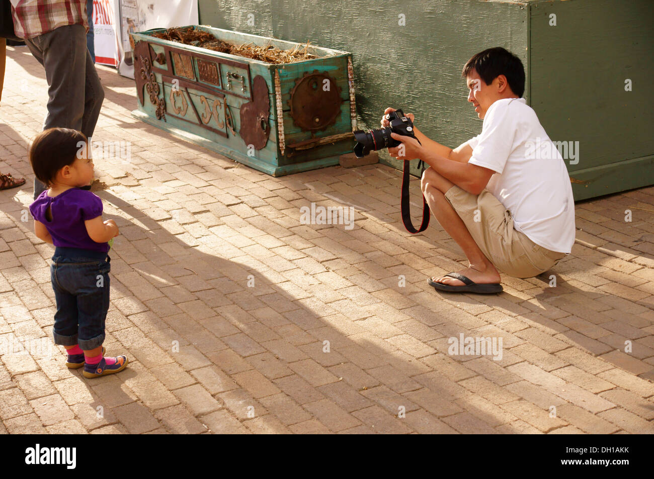 asian father dad parent taking picture of daughter adult grownup mature man male human fellow gentleman guy he Stock Photo