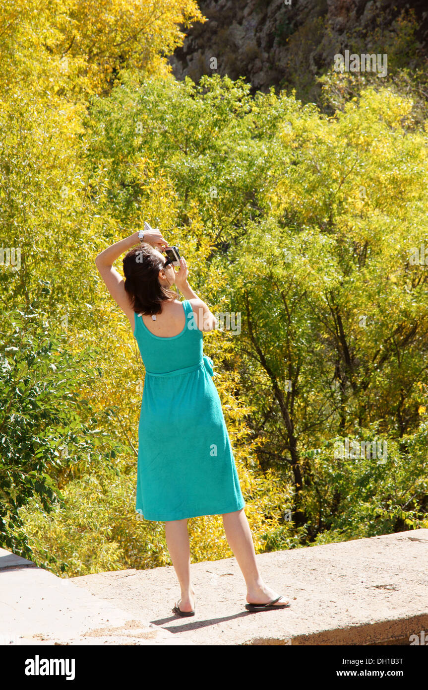 female photographer taking picture in woods outdoors adult grownup mature woman human girl she art aptitude Stock Photo