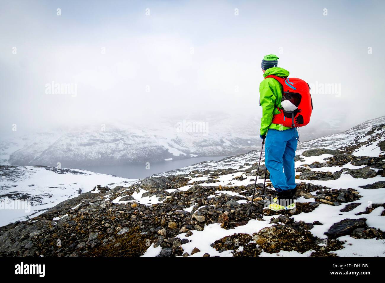 Hiker taking a look at fjord in mountain scenery, Norway, Europe Stock ...