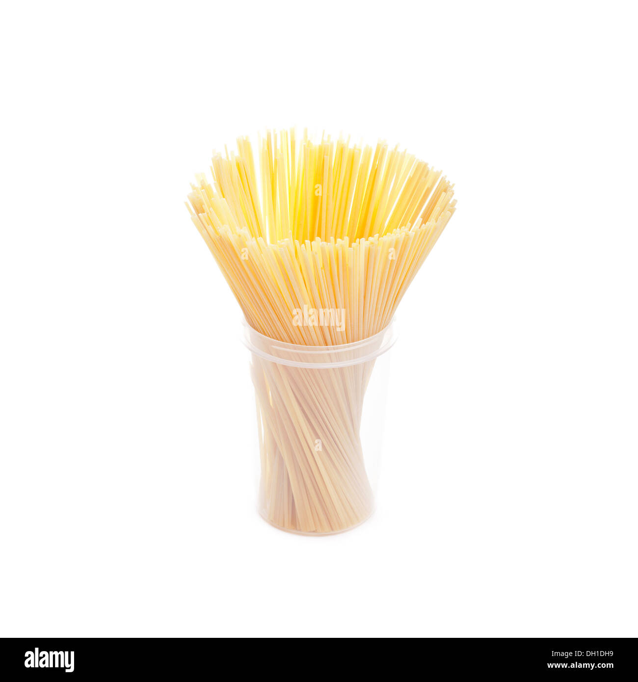 Bunch of spaghetti in plastic box isolated on white Stock Photo