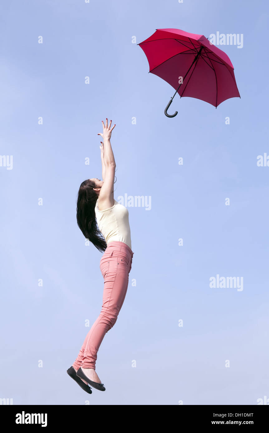 woman jumping with umbrella Stock Photo - Alamy