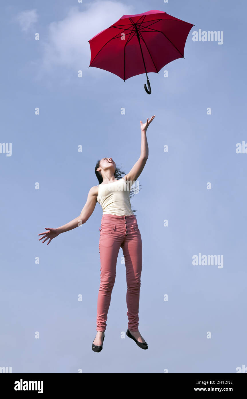 woman jumping with umbrella Stock Photo - Alamy