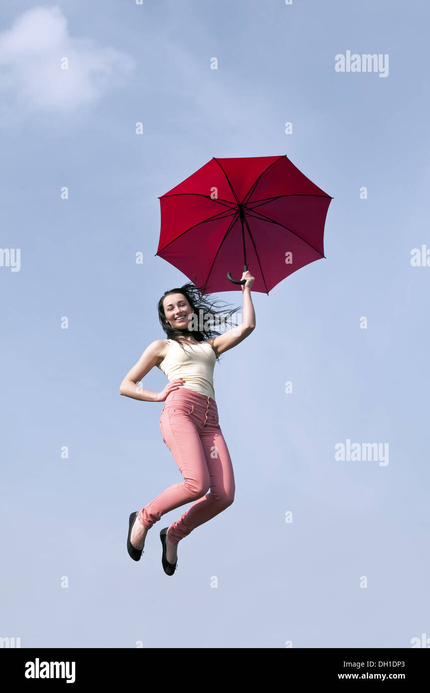 woman jumping with umbrella Stock Photo - Alamy