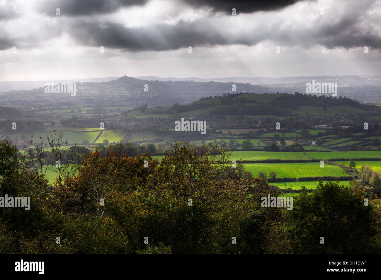 View of the Somerset Levels and Glastonbury Tor in the mist with a dramatic sky Stock Photo
