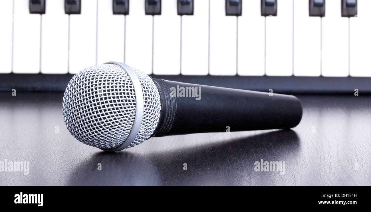 Microphone and piano keyboard in distance,closedup Stock Photo Alamy