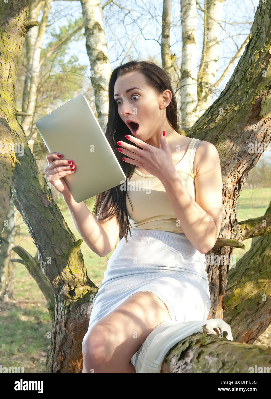 shocked young woman with tablet pc Stock Photo