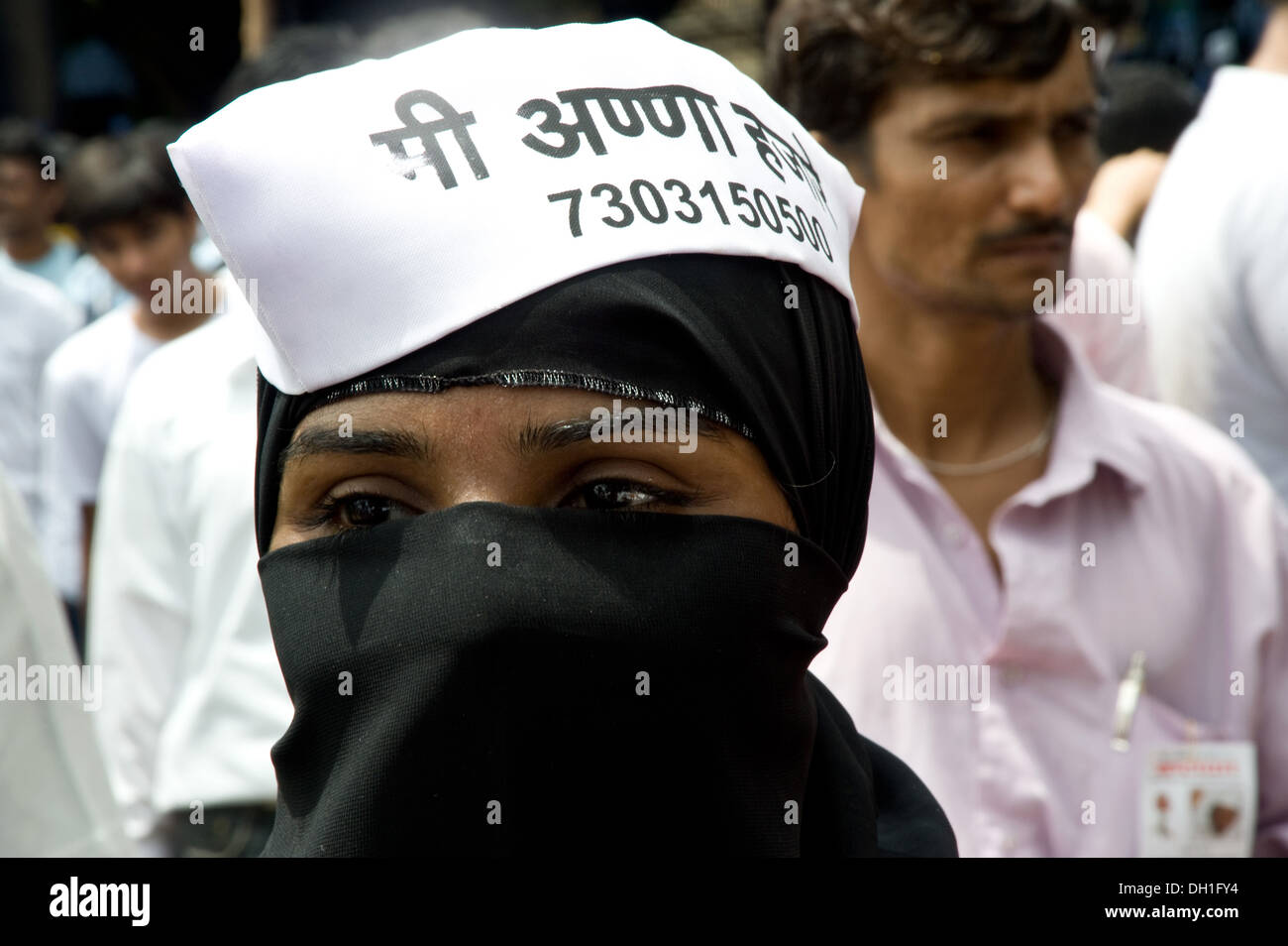woman in white cap for Anna Hazare agitation young people agitation demonstration protest Anna Hazare supporters Bombay Mumbai Maharashtra India Asia Stock Photo