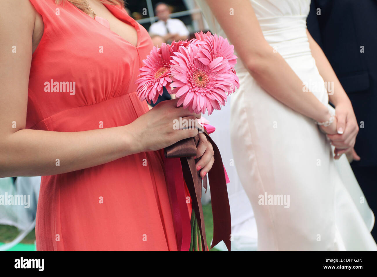 Maid of honor holding flowers alongside bride, Zagreb, Croatia Stock Photo