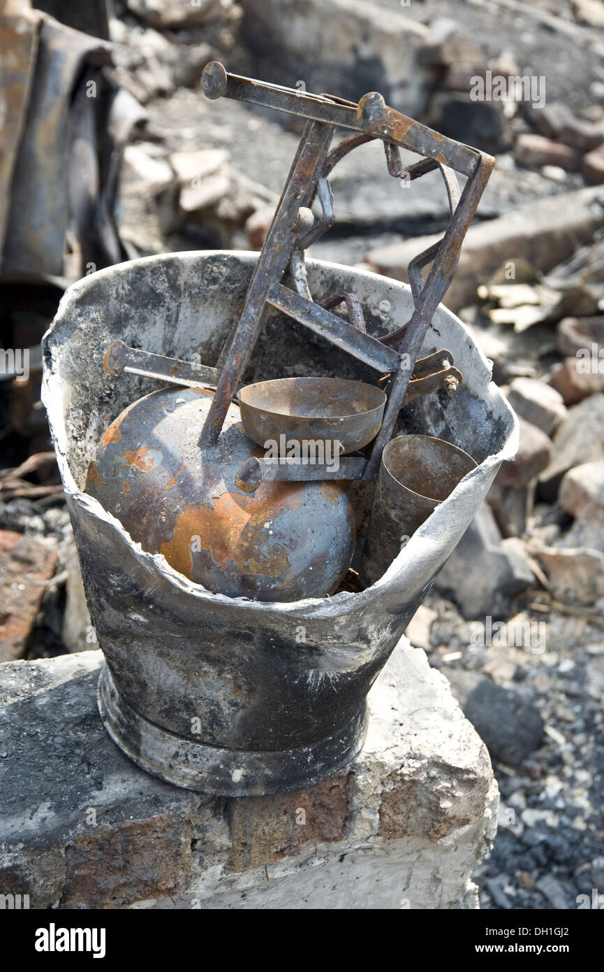 damaged destroyed things in bucket after fire bandra slums mumbai Maharashtra India Asia Stock Photo