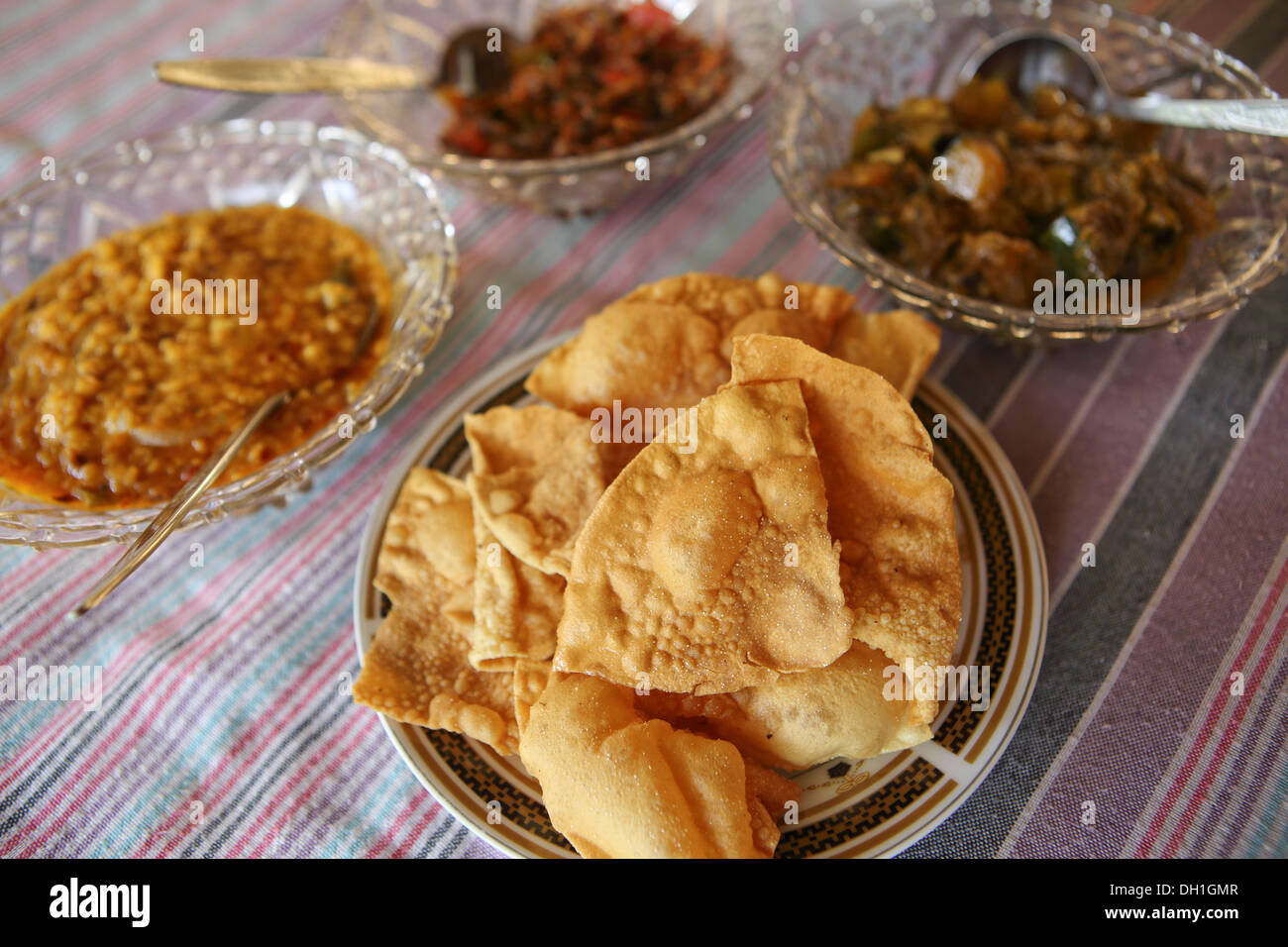 Traditional Sri Lankan rice curry dish with fresh poppadoms Stock Photo