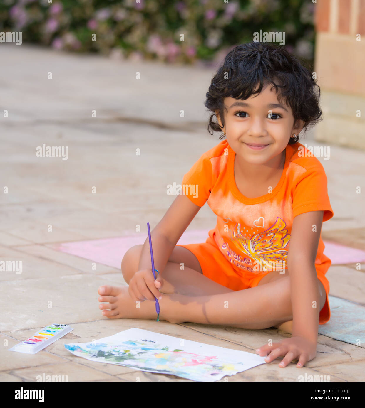 Little Child Painting on a Patio Stock Photo - Alamy