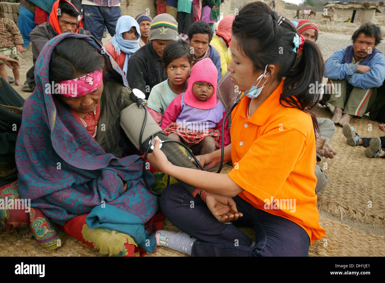 Health worker examining sick women who are brickmakers living in dangerous circumstances, Godavari, Nepal. Stock Photo