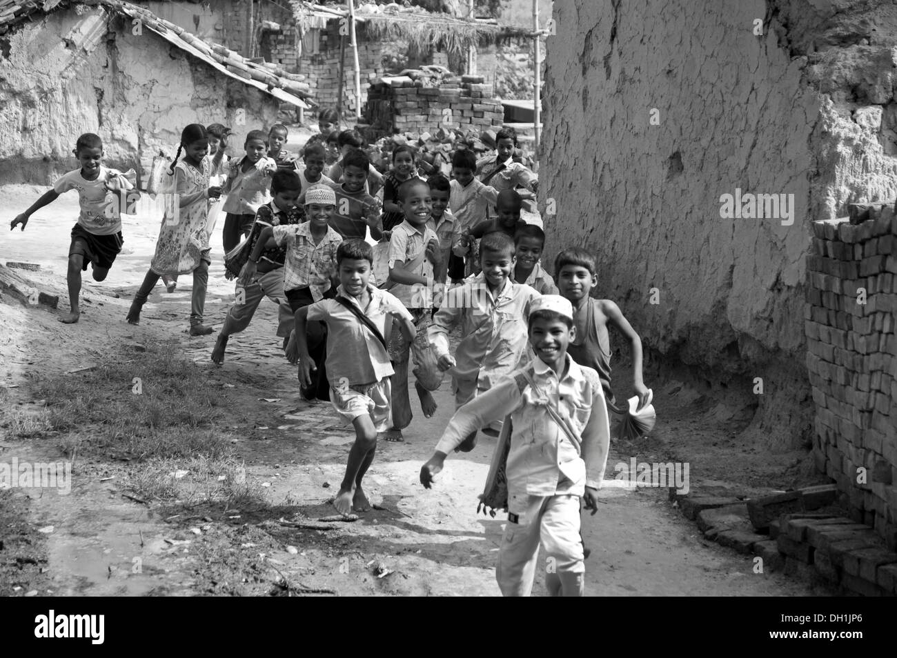 Children , boys and girls running home after rural school in village , varanasi , uttar pradesh , India , Asia Stock Photo