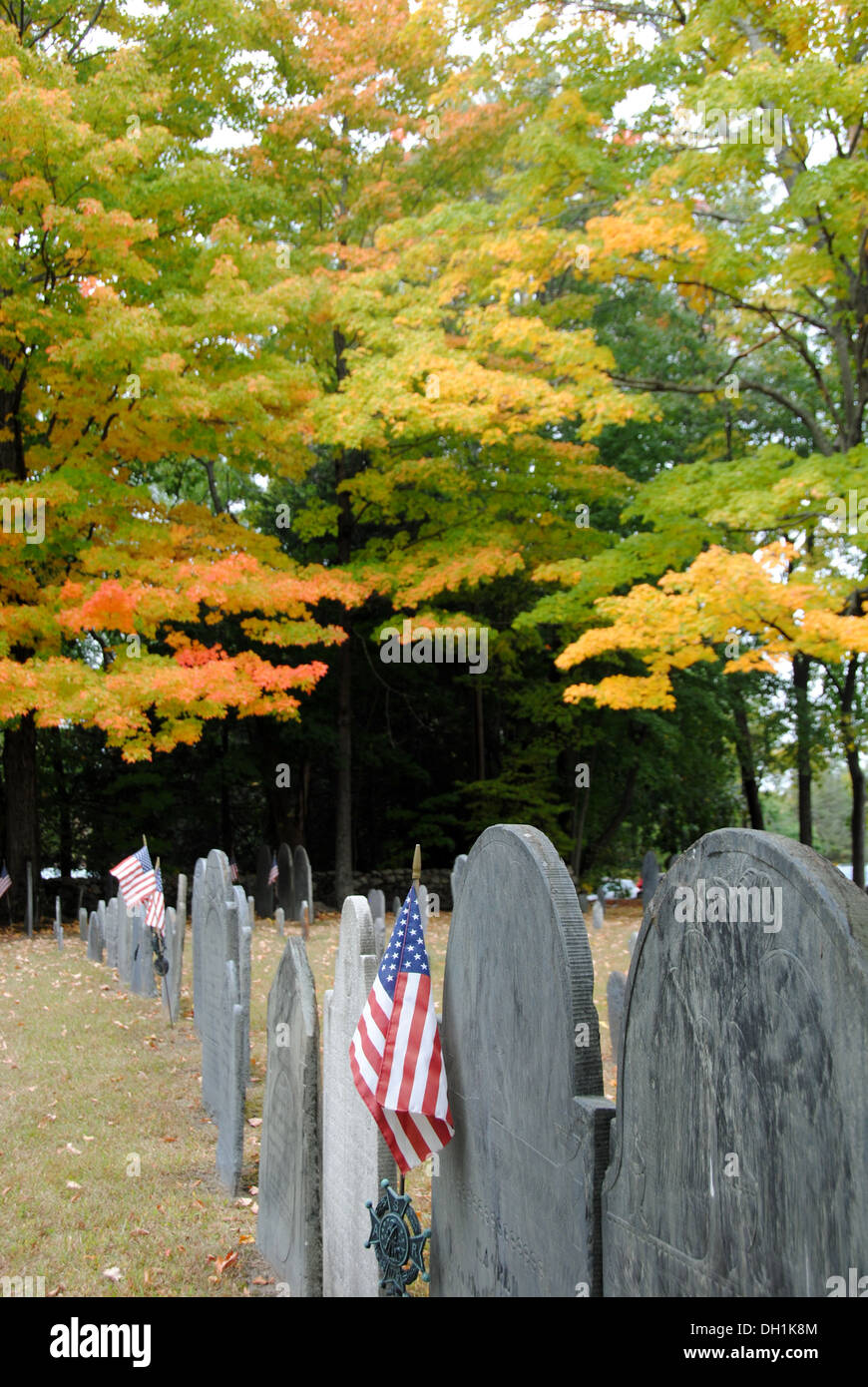 Concord MA historic cemetery with fall foliage and American flags. Stock Photo