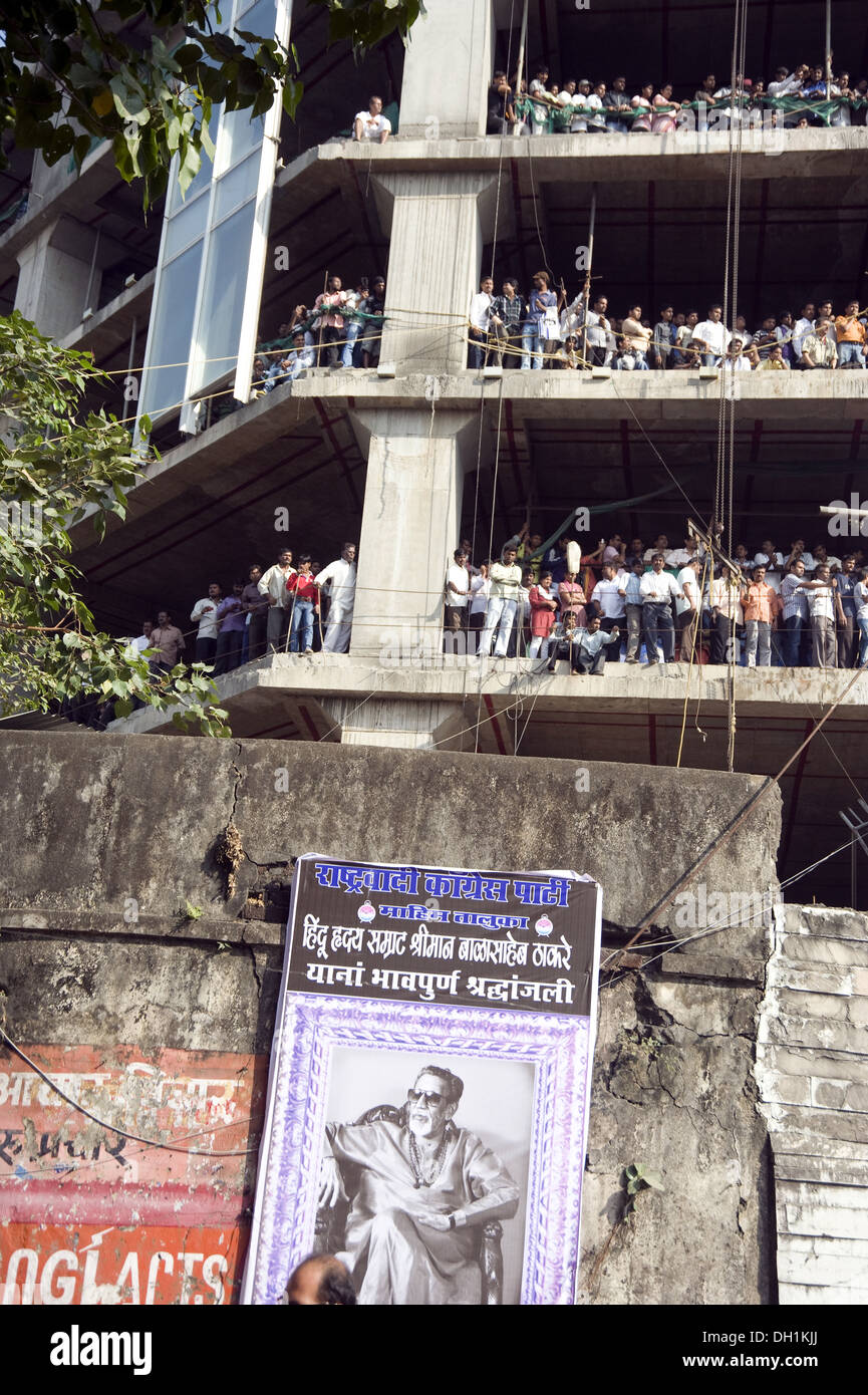 Crowd standing in building under construction to see funeral procession of Shiv Sena Chief Bal Thackeray mumbai maharashtra india asia Stock Photo