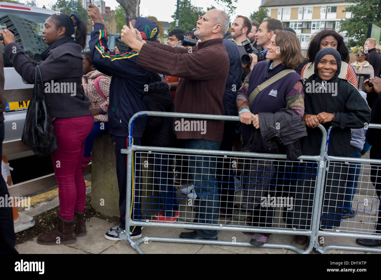 Locals from the Loughborough Estate try to catch a glimpse of the Queen