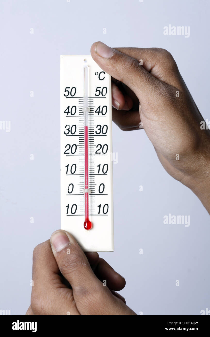 Weather temperature meter showing 35 degrees celsius centigrade close up of Temperature meter holding in both hands MR#743AE Stock Photo