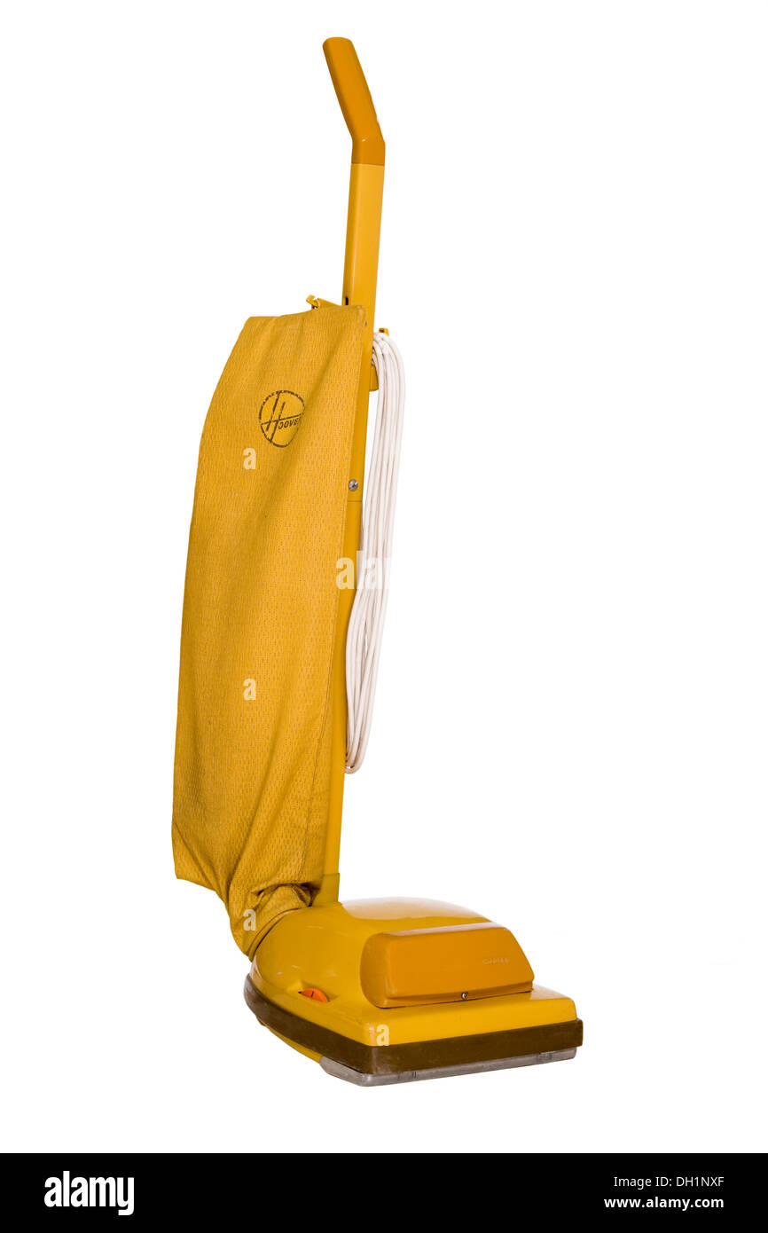 1970s / 1980s hoover vacuum cleaner with mustard yellow dust bag as a cut out on white background. Stock Photo