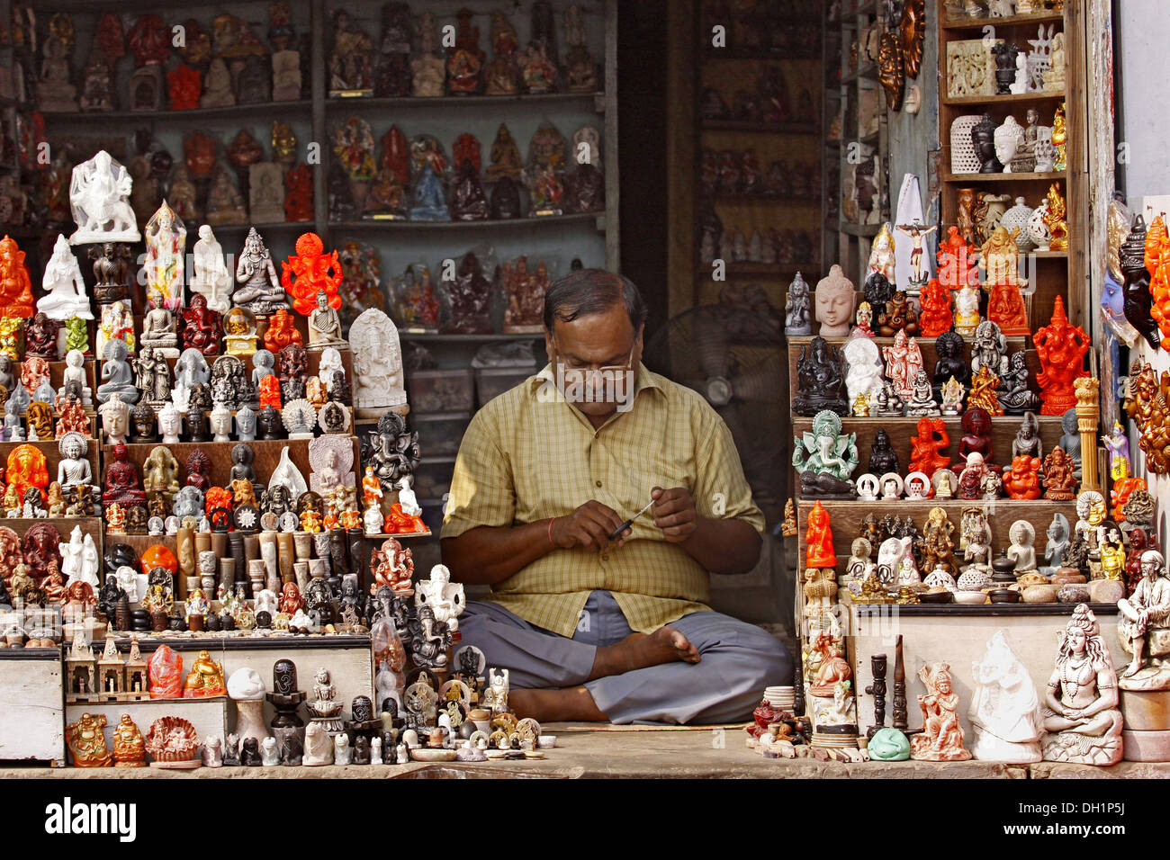 shopkeeper selling idols of Hindu Gods Goddesses Varanasi Uttar Stock