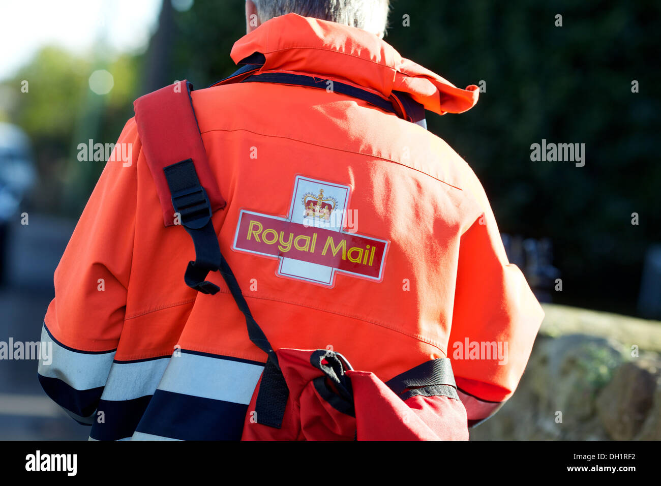 royal mail postman on his round carrying a post bag Stock Photo