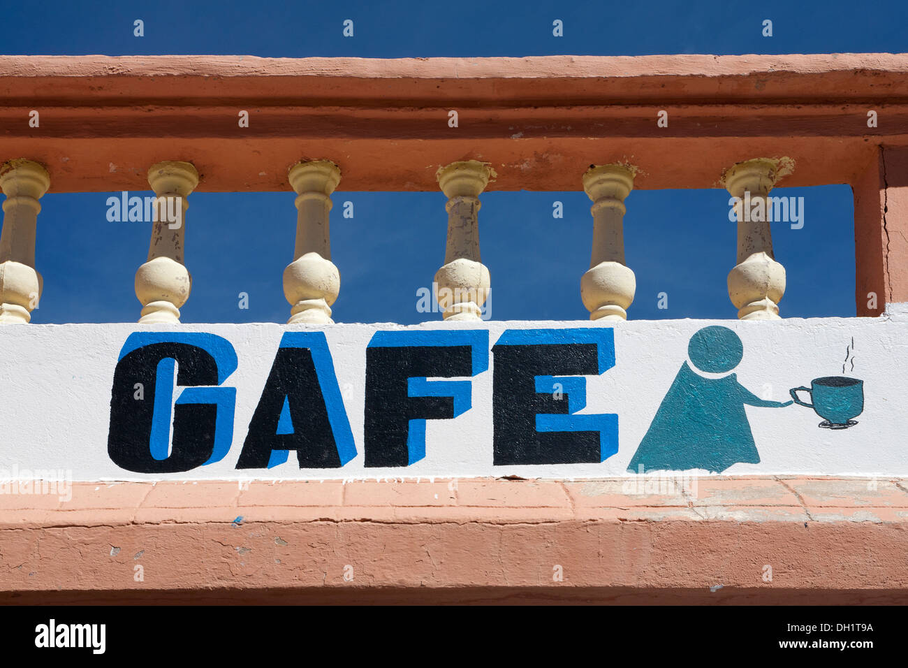 Detail of painted cafe graphics under a balustrade and against a bright blue sky Morocco Stock Photo