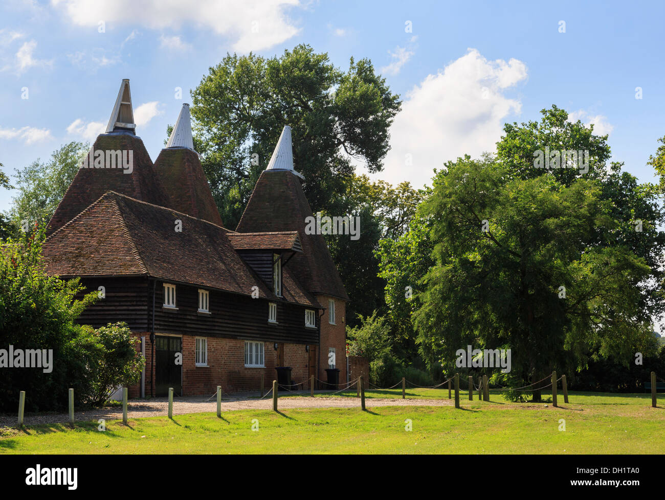 Former old Oast houses converted into unusual homes on a village green in Littlebourne, Kent, England, UK, Britain Stock Photo