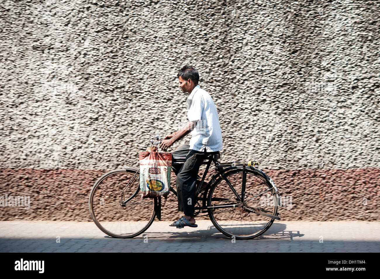 Man riding his bicycle - street scene from Mumbai, Maharashtra Stock Photo