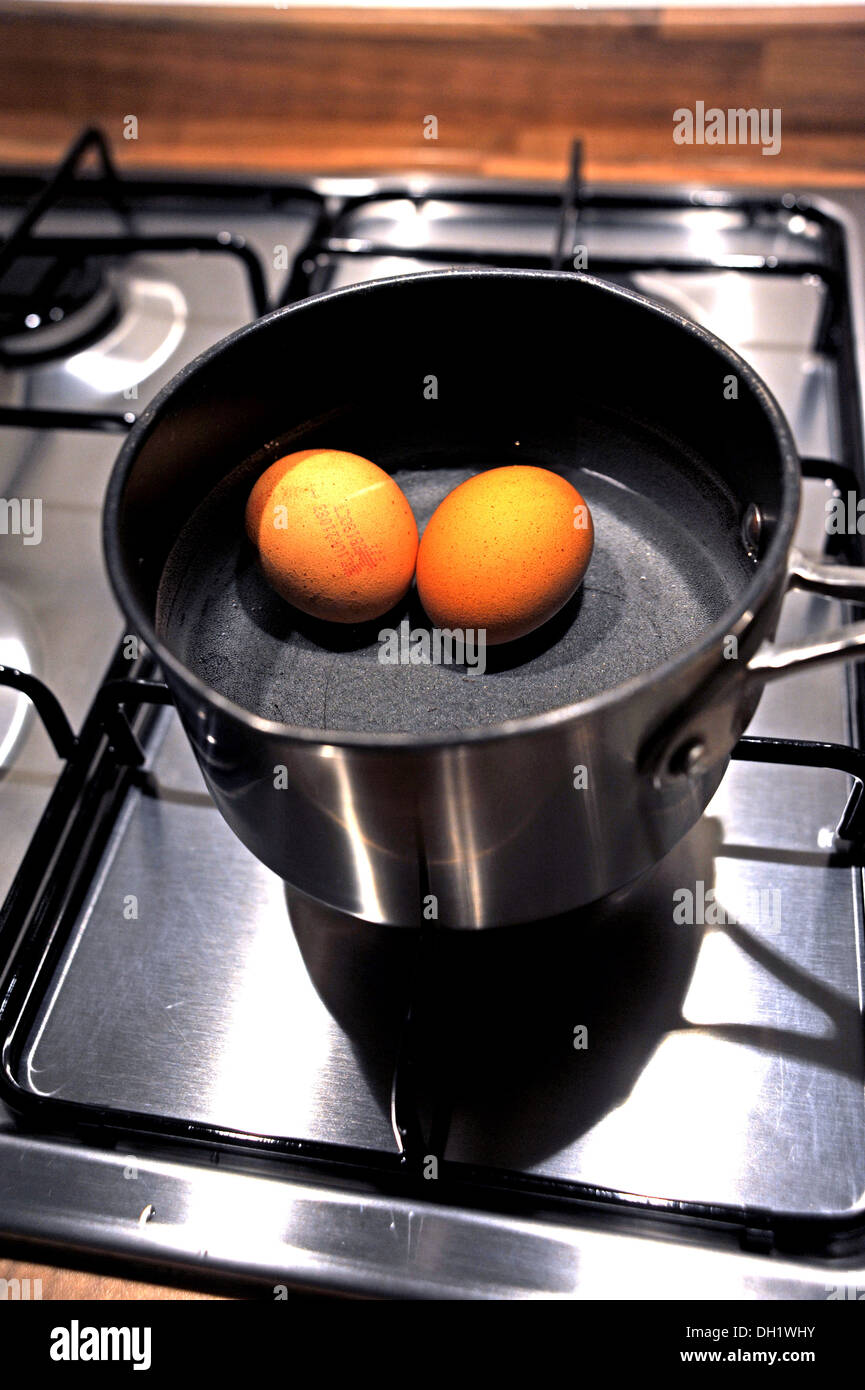 Two free range eggs boiling in a saucepan Stock Photo