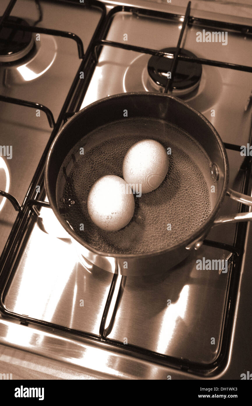Two free range eggs boiling in a saucepan Stock Photo