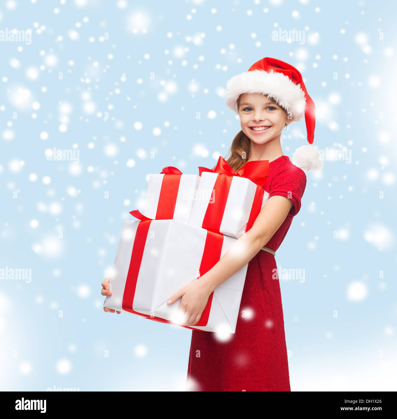 girl in santa helper hat with many gift boxes Stock Photo - Alamy