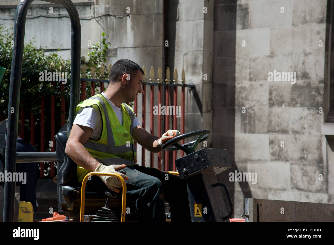 Man driving roadwork vehicle, London, England Stock Photo